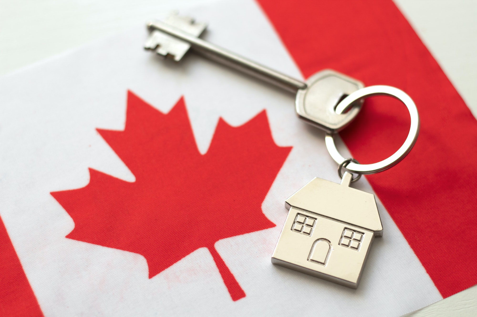 House with the flag of Canada. Immigration to Canada.